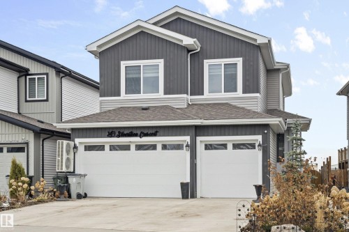 Contemporary two-story residence featuring a dual-tone facade with dark vertical siding and light horizontal siding - 249 Silverstone Crescent, Stony Plain, AB - Outdoor