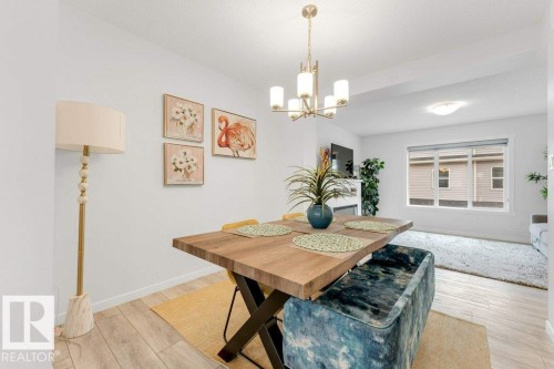 Dining area featuring wood-finish flooring, a contemporary chandelier, and recessed lighting - 53 1110 Daniels Link Link, Edmonton, AB - Indoor Photo Showing Dining Room