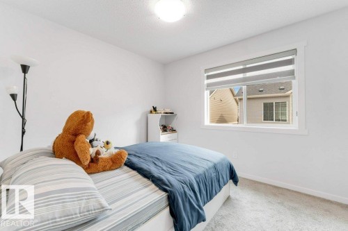 Bedroom featuring white walls and neutral-toned carpeting - 53 1110 Daniels Link Link, Edmonton, AB - Indoor Photo Showing Bedroom