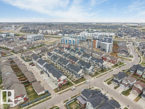 Expansive aerial view showcasing a developed residential area with a mix of detached homes and multi-story townhomes - 53 1110 Daniels Link Link, Edmonton, AB - Outdoor With View