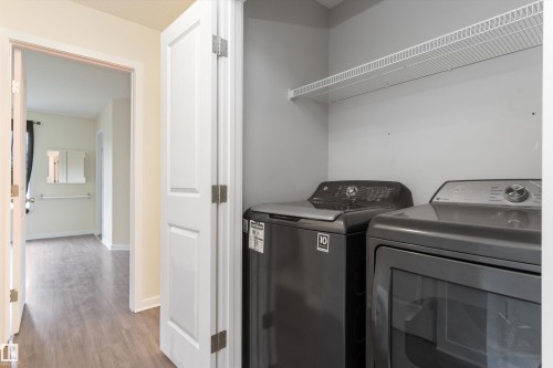 Dedicated laundry area featuring a wire storage shelf and gray appliances - 336 Watt Boulevard, Edmonton, AB - Indoor Photo Showing Laundry Room