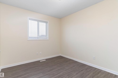 Neutral-toned walls complement wood-finish flooring - 336 Watt Boulevard, Edmonton, AB - Indoor Photo Showing Other Room