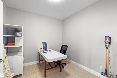 Neutral wall finishes complement the wood-finish flooring in this versatile room - 3807 Claxton Close, Edmonton, AB - Indoor Photo Showing Office
