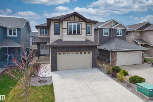 Multi-level residence featuring a two-car attached garage and a concrete driveway - 3807 Claxton Close, Edmonton, AB - Outdoor With Facade