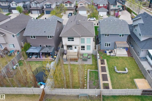 Rear exterior featuring a multi-level deck, two covered gazebo structures, and a spacious fenced yard - 3807 Claxton Close, Edmonton, AB - Outdoor