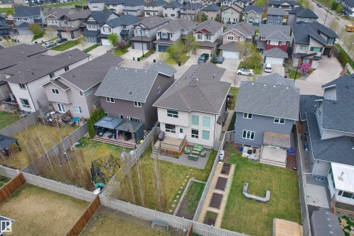Rear exterior featuring a spacious wooden deck and large windows - 3807 Claxton Close, Edmonton, AB - Outdoor With View