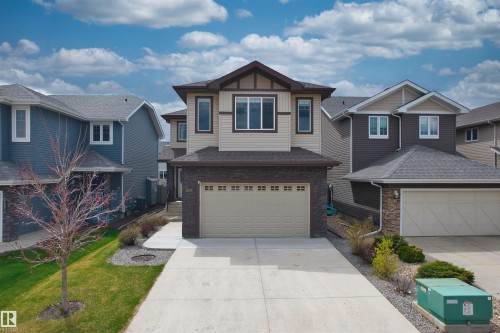 Two-story residence featuring a neutral-toned facade with dark brown and beige siding - 3807 Claxton Close, Edmonton, AB - Outdoor With Facade