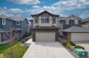 Two-story residence featuring a neutral-toned facade with dark brown and beige siding - 3807 Claxton Close, Edmonton, AB  - Outdoor With Facade 
