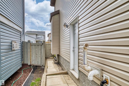 Concrete pathway alongside beige horizontal siding - 3807 Claxton Close, Edmonton, AB - Outdoor