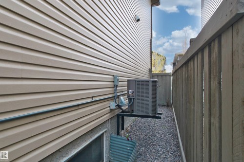 Tan horizontal vinyl siding with a single pane window - 3807 Claxton Close, Edmonton, AB - Outdoor With Exterior