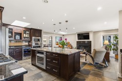 Kitchen island with granite countertop and integrated oven - 