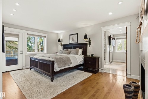 Hardwood flooring throughout, recessed ceiling lighting, and abundant natural light from multiple windows - 9010 120 Street, Edmonton, AB - Indoor Photo Showing Bedroom
