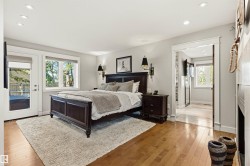Hardwood flooring throughout, recessed ceiling lighting, and abundant natural light from multiple windows - 