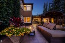 Spacious concrete patio featuring a built-in fire pit, stone-clad walls, and a curved patio cover with recessed lighting - 9010 120 Street, Edmonton, AB  - Outdoor With Deck Patio Veranda 