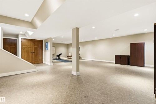 Spacious room featuring light-colored flooring, recessed lighting, and a neutral wall palette - 9010 120 Street, Edmonton, AB - Indoor