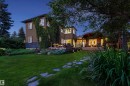 Expansive lawn with stone pathway leading to a multi-level dwelling - 9010 120 Street, Edmonton, AB  - Outdoor With Deck Patio Veranda 