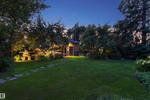 Expansive lawn with a stone pathway, mature trees, and landscape lighting - 9010 120 Street, Edmonton, AB - Outdoor