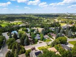 Aerial perspective showcasing a residential area with mature trees and established homes - 