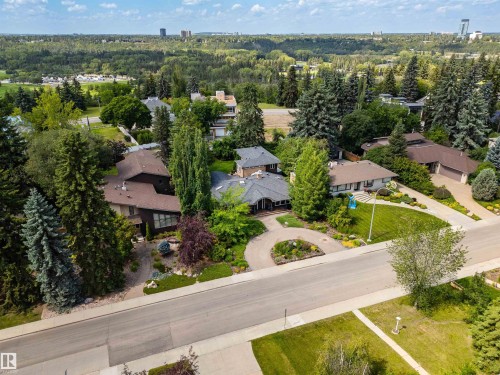 Private residential setting featuring mature landscaping, paved roads, and extensive tree cover - 9010 120 Street, Edmonton, AB - Outdoor With View