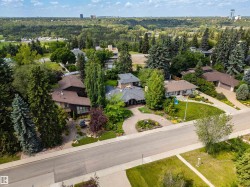 Private residential setting featuring mature landscaping, paved roads, and extensive tree cover - 