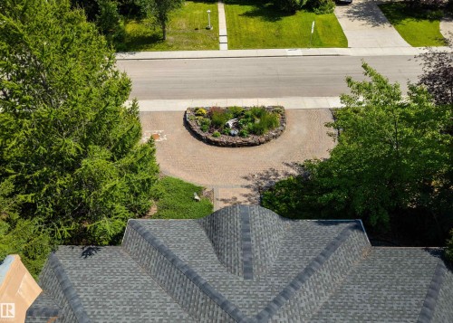 Asphalt shingle roof with a prominent ridgeline, complemented by a paver driveway - 9010 120 Street, Edmonton, AB - Outdoor