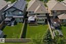 Expansive green lawn with a wooden privacy fence - 469 Ainslie Crescent Sw, Edmonton, AB  - Outdoor 