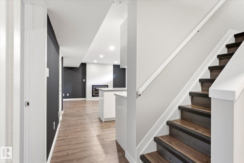 Staircase featuring wood-finish treads and risers with white painted handrails - 111 Grosvenor Boulevard, St. Albert, AB - Indoor Photo Showing Other Room