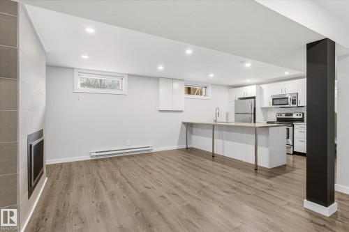 Open-concept living area featuring wood-finish flooring and recessed lighting - 111 Grosvenor Boulevard, St. Albert, AB - Indoor