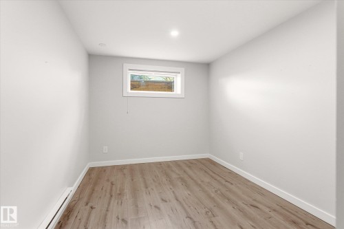 Room featuring wood-finish flooring, white baseboards, and light gray walls - 111 Grosvenor Boulevard, St. Albert, AB - Indoor Photo Showing Other Room