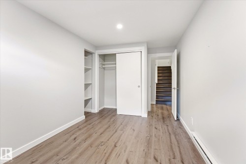 Bedroom featuring wood-finish flooring, recessed lighting, and a closet with sliding doors - 111 Grosvenor Boulevard, St. Albert, AB - Indoor Photo Showing Other Room