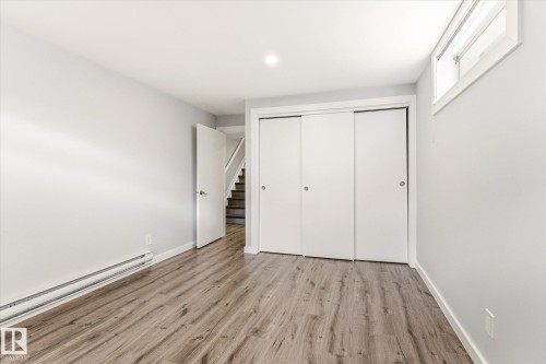 Room featuring wood-finish flooring, white walls, and a window providing natural light - 111 Grosvenor Boulevard, St. Albert, AB - Indoor Photo Showing Other Room