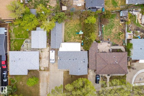 Aerial perspective showcasing multiple properties with various roof styles and yard configurations - 111 Grosvenor Boulevard, St. Albert, AB - Outdoor
