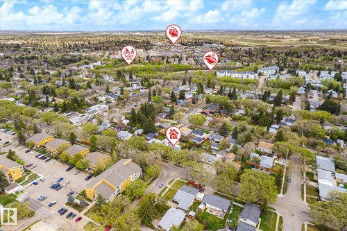 Aerial perspective of a residential neighborhood with a variety of housing types, mature trees, and local amenities - 111 Grosvenor Boulevard, St. Albert, AB - Outdoor With View