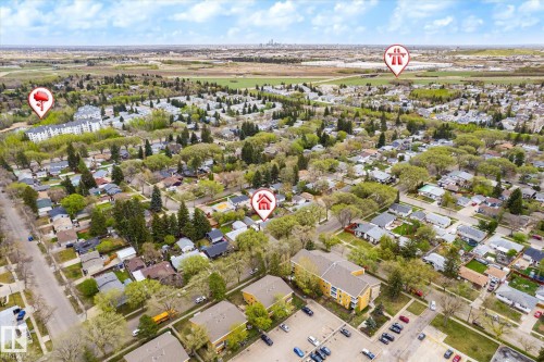 Aerial perspective of a residential neighborhood with established trees, featuring a mix of single-family homes and multi-story buildings - 111 Grosvenor Boulevard, St. Albert, AB - Outdoor With View