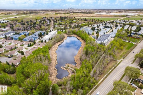 Natural water feature surrounded by mature trees and residential areas - 111 Grosvenor Boulevard, St. Albert, AB - Outdoor With View