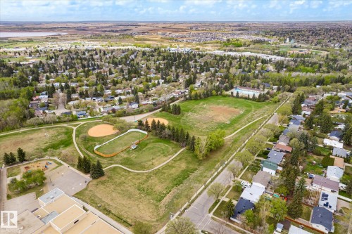 Aerial perspective showcasing a residential area bordered by abundant green spaces, including multiple sports fields and walking paths - 111 Grosvenor Boulevard, St. Albert, AB - Outdoor With View