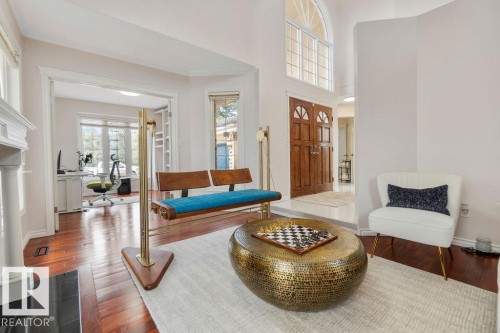 Grand entryway featuring double wooden doors and an arched transom window - 956 Ogilvie Boulevard, Edmonton, AB - Indoor Photo Showing Living Room