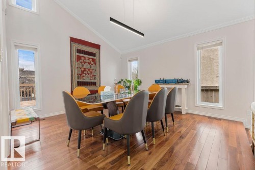 Dining area featuring wood-finish flooring, vaulted ceiling, and multiple windows - 956 Ogilvie Boulevard, Edmonton, AB - Indoor Photo Showing Dining Room