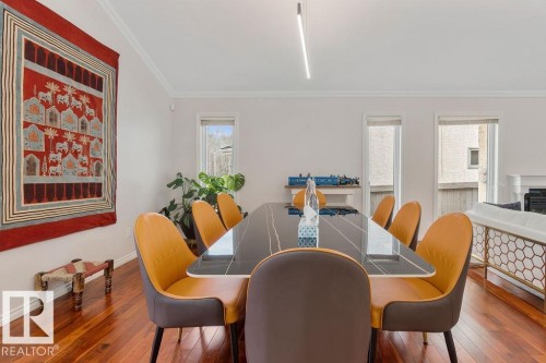 Spacious dining area featuring wood-finish flooring, crisp white baseboards, and crown molding - 956 Ogilvie Boulevard, Edmonton, AB - Indoor Photo Showing Dining Room