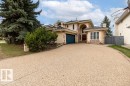 Stucco and brick exterior with a prominent arched entry, a two-car garage, and an exposed aggregate driveway - 956 Ogilvie Boulevard, Edmonton, AB  - Outdoor 