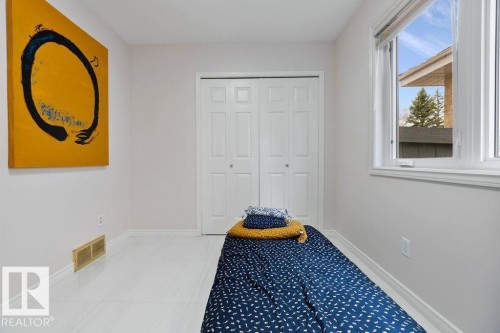 Room featuring white walls, bright window, and wood-finish flooring - 956 Ogilvie Boulevard, Edmonton, AB - Indoor Photo Showing Bedroom