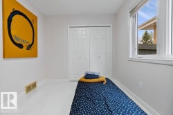 Room featuring white walls, bright window, and wood-finish flooring - 