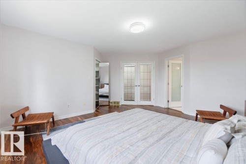 Spacious interior featuring wood-finish flooring, white walls, and a ceiling-mounted light fixture - 956 Ogilvie Boulevard, Edmonton, AB - Indoor Photo Showing Bedroom