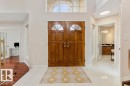 Grand entryway featuring double wood doors with arched glass inserts - 956 Ogilvie Boulevard, Edmonton, AB  - Indoor Photo Showing Other Room 