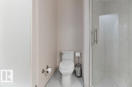 Enclosed shower with clear glass door and brushed nickel hardware - 956 Ogilvie Boulevard, Edmonton, AB - Indoor Photo Showing Bathroom