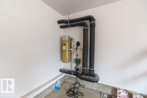 Utility area featuring a central vacuum system, insulated piping, and a dedicated electrical outlet - 956 Ogilvie Boulevard, Edmonton, AB - Indoor Photo Showing Other Room