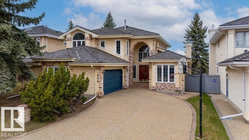 Stucco exterior with stone accents and a multi-pitched roofline - 956 Ogilvie Boulevard, Edmonton, AB - Outdoor With Facade