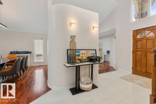 Entryway featuring a solid wood front door with an arched transom, a curved architectural wall, and recessed lighting - 956 Ogilvie Boulevard, Edmonton, AB - Indoor Photo Showing Other Room
