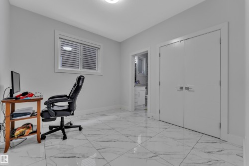 Room featuring large format marble-look tile flooring, white baseboards, and light gray walls - 1827 22 Street Nw, Edmonton, AB - Indoor Photo Showing Office