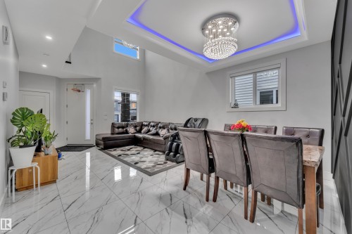 Formal dining area featuring a tiered crystal chandelier with recessed lighting and accent lighting - 1827 22 Street Nw, Edmonton, AB - Indoor